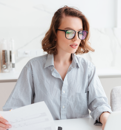 beautiful-thoughtful-woman-glasses-striped-shirt-working-with-documents-home 1